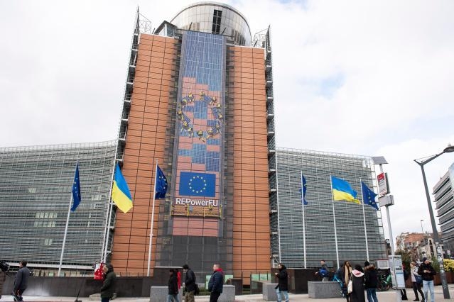 European and Ukrainian flags raised in front of the Berlaymont building to commemorate the second year of the Russian invasion of Ukraine